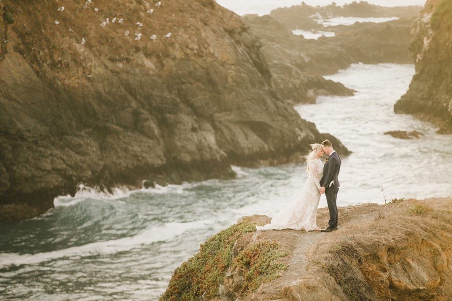 Epic photo of bride and groom on a California ocean cliff