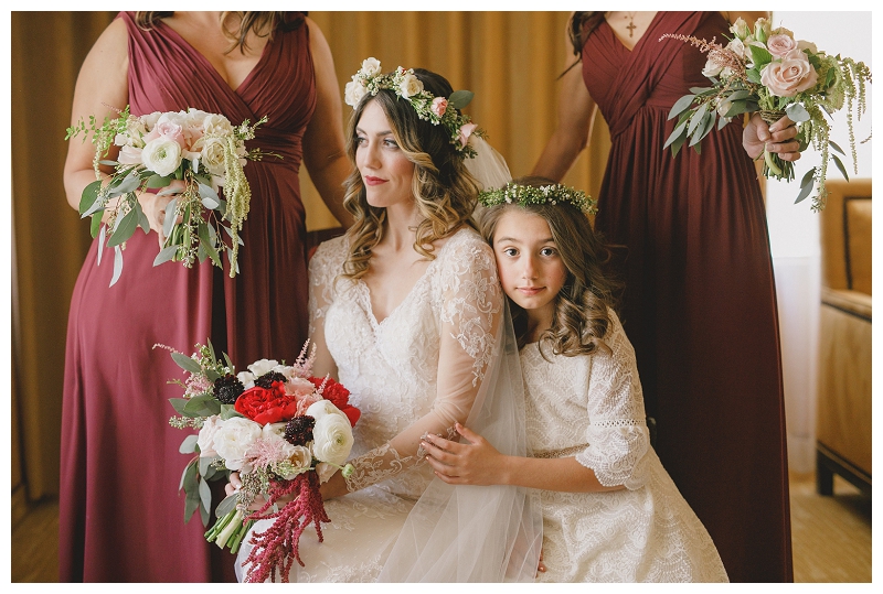 Dramatic portrait of bride and bridesmaids wearing wine colored dresses