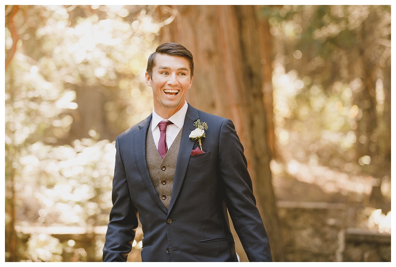 Excited groom reaction during first look in the forest