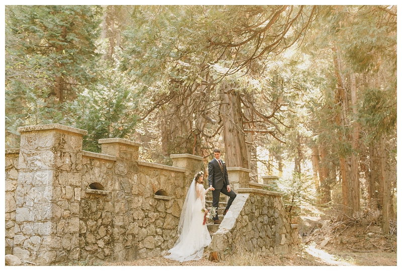 Bride and groom at stone castle ruin in the forest of Lake Arrowhead California