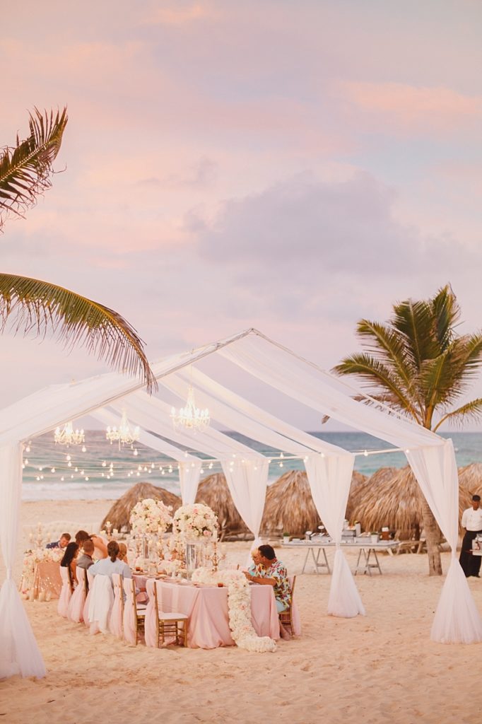 Tented wedding reception on the beach during sunset at Hard Rock Punta Cana