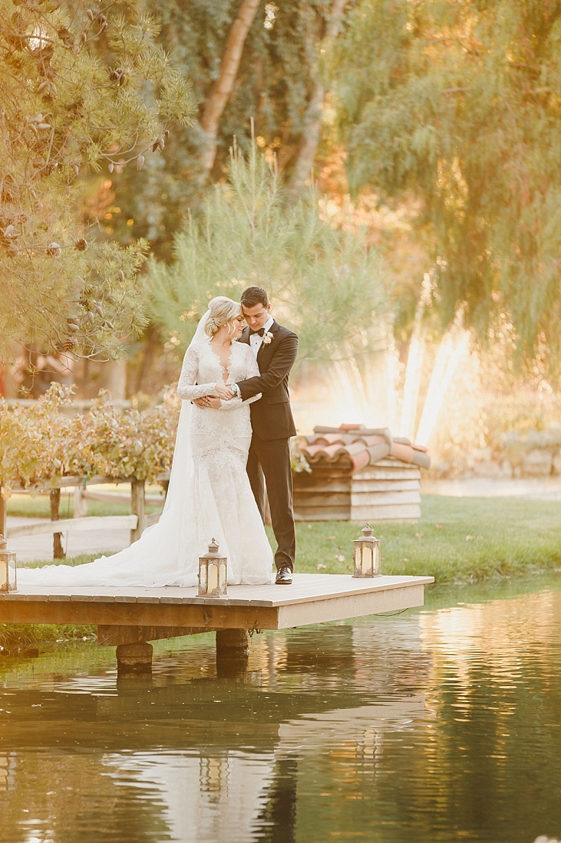 Romantic sunset photo of bride and groom on dock at Lake Oak Meadows