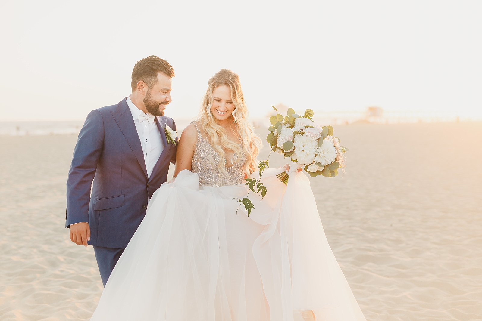 bride and groom on the beach at sunset in Huntington CA